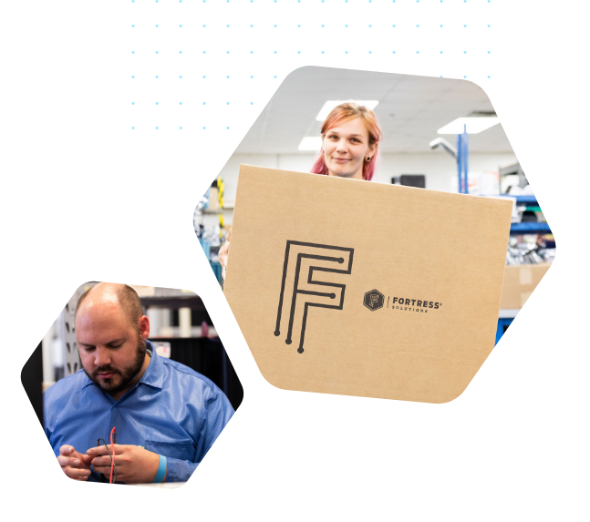 A woman holding a large box with a Fortress logo and a man holding wires