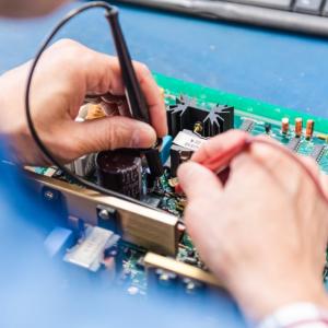 Technician soldering on a PCB